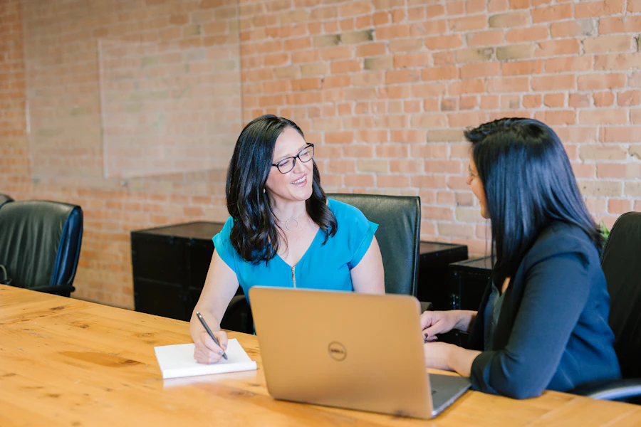 Two colleagues reviewing feedback together at a desk