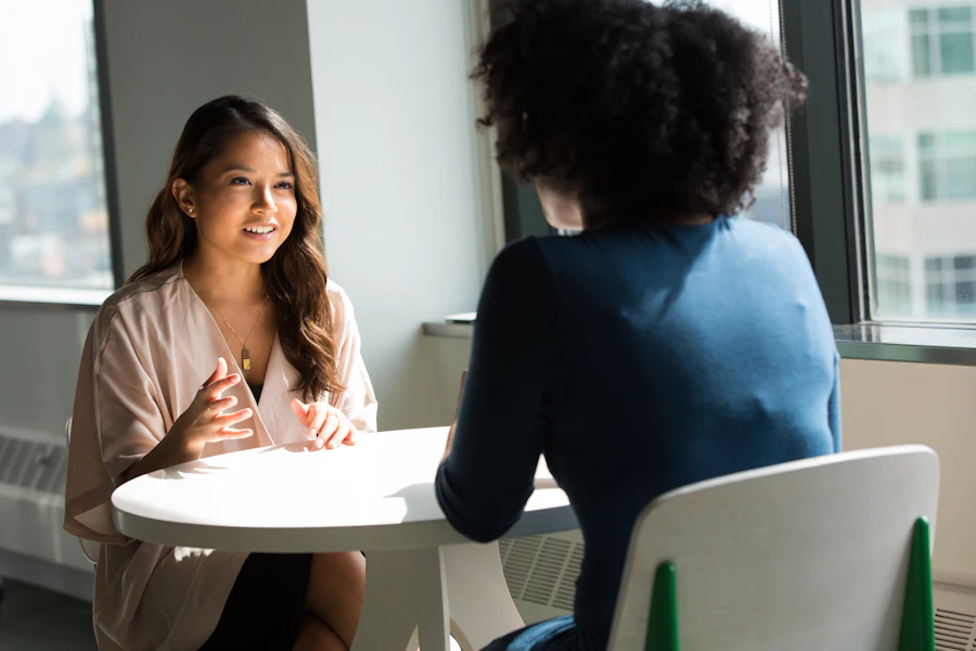 A one-to-one coaching conversation in a bright office